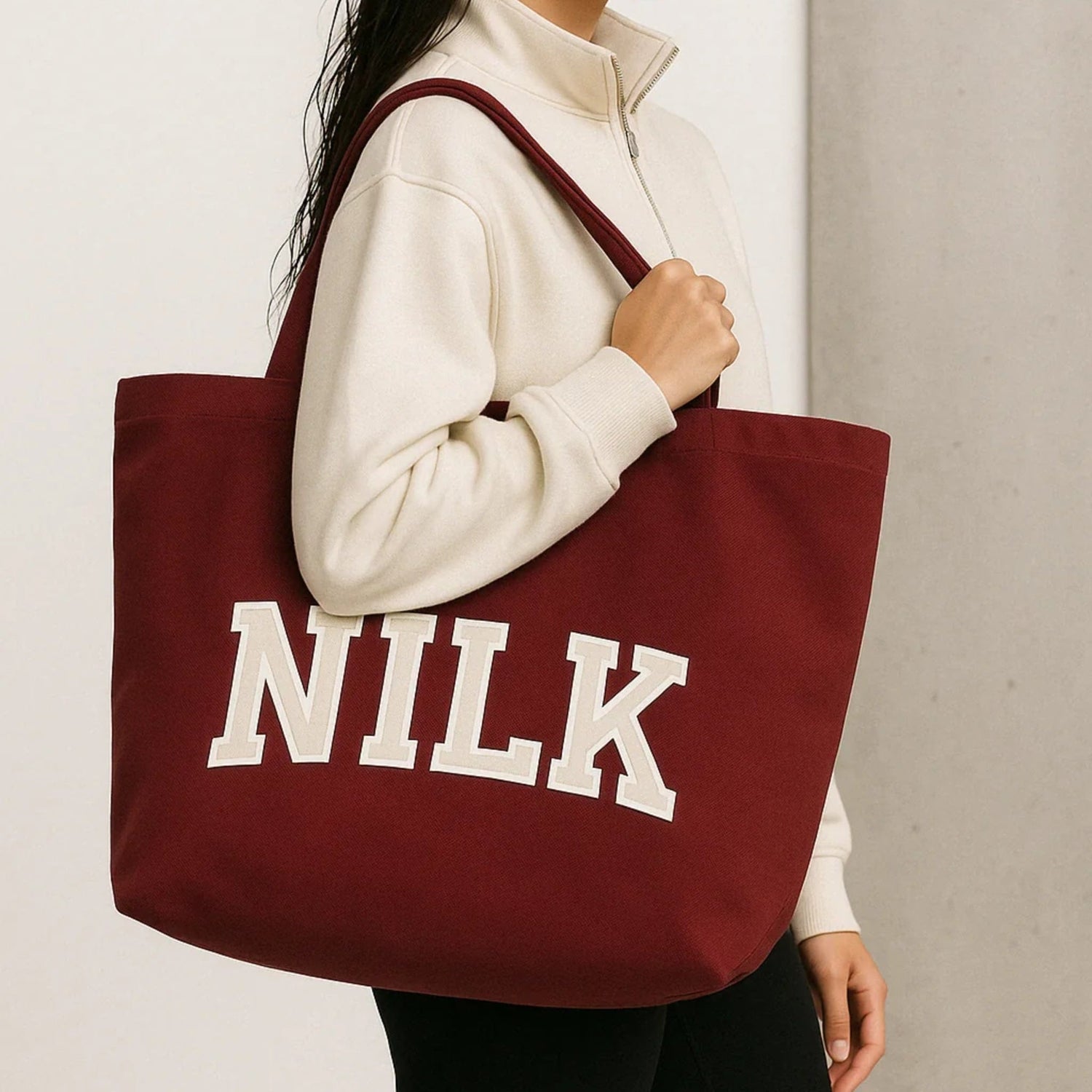 Large maroon NILK canvas tote bag with bold varsity logo, ideal for school, gym or weekend errands