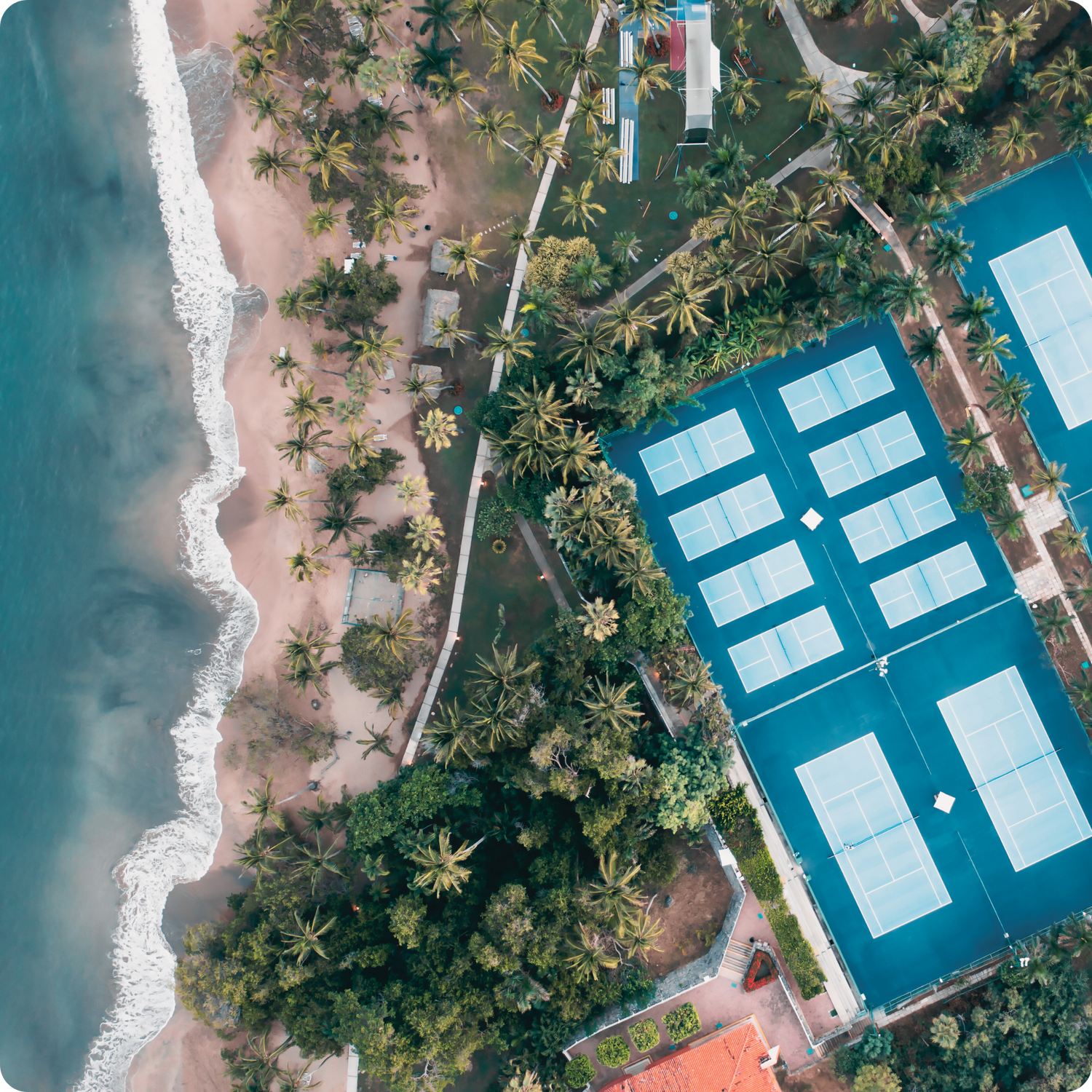 Aerial view of pickleball courts near the coastline, representing Bainbridge Island, Washington—the birthplace of pickleball in 1965.